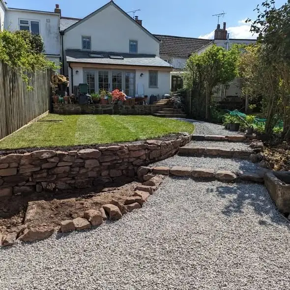 Cottage garden with stone steps and planted borders