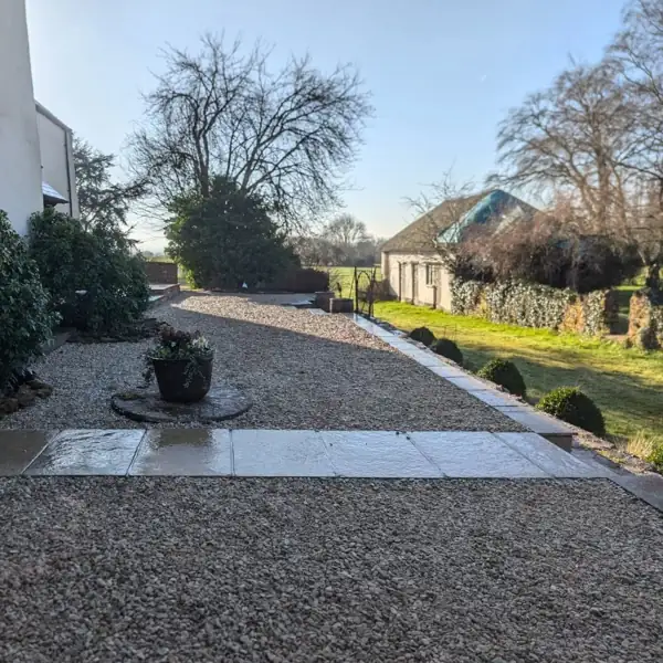 Low-maintenance gravel garden with paved pathway