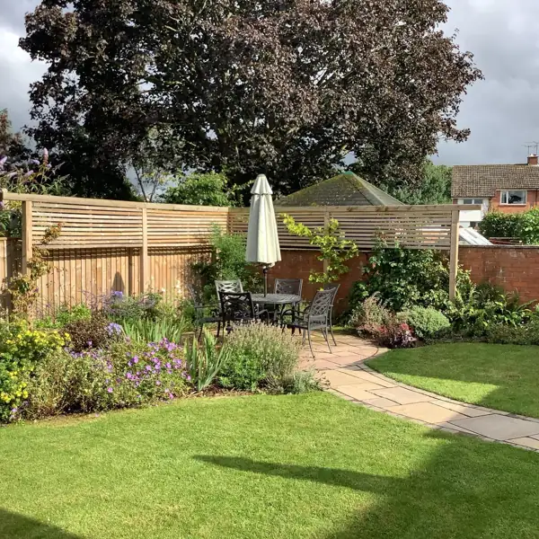 Landscaped garden with new lawn, planted borders and paved path