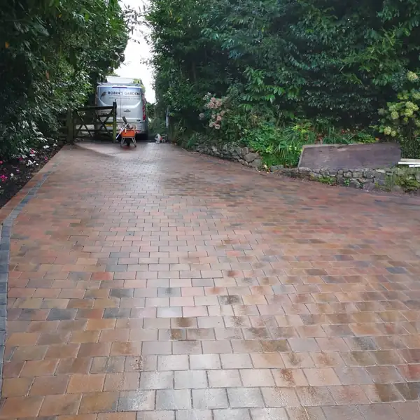 Reclaimed brick garden path laid in herringbone pattern